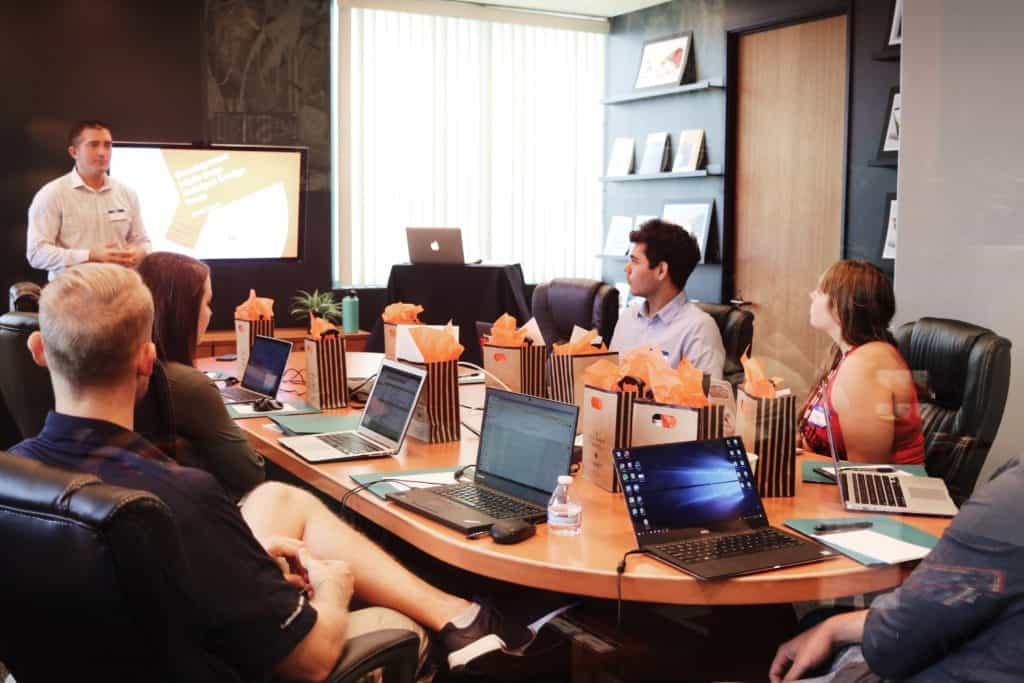 a group of people having a meeting in a conference room